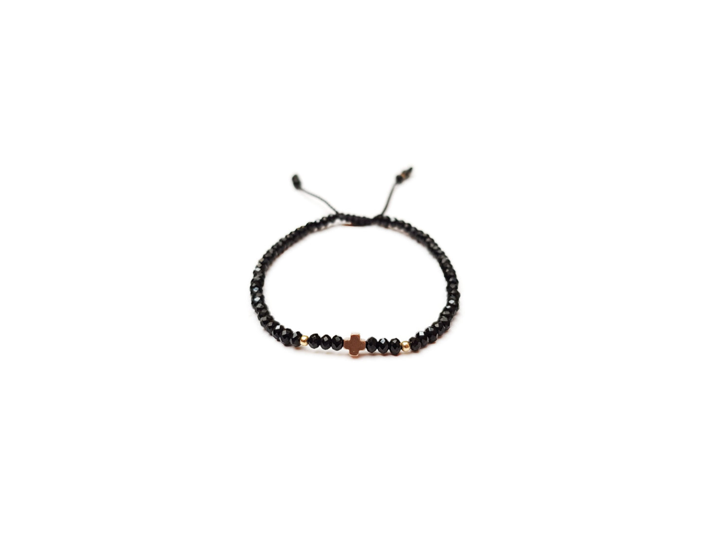 Pulsera de cristales negros con cruz chica de hematita rosa